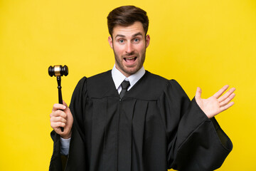 Wall Mural - Judge caucasian man isolated on yellow background with shocked facial expression