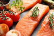 Fresh raw salmon and ingredients for marinade on grey table, closeup