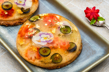 Canvas Print - Lemon jelly globes with fresh fruit, edible flowers and gold flakes on pistachio biscuit - gourmet dessert