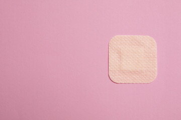 contraceptive patch on pink background, top view. space for text