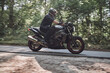 © perfectlab - Blurred Motion A young man biker in a helmet quickly rides at high speed on a forest road, in motion