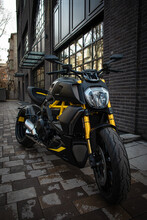 A Sporty Black And Yellow Motorcycle Is Street