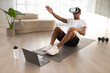 © Prostock-studio - African american guy doing vurtual workout at home