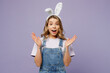 Young surprised shocked fun woman wear white casual clothes bunny rabbit ears look camera spread hands say wow isolated on plain pastel light purple background studio. Lifestyle Happy Easter concept.