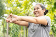 © 9nong - Old senior woman stretching arm and hand joint muscle, exercising in green park, breathing clean air, good and healthy life quality, self care and wellness concept image