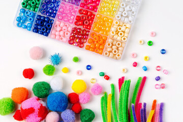 Wall Mural - Set for children's crafts. Pipe Cleaners, beads and colorful pom-poms. Different multi-colored supplies and materials for DIY art activity for kids. Motor skills, creativity and  hobby.