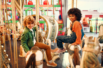 Kids having fun on a carnival Carousel