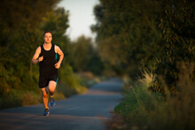 Shot Of A Young Male Athlete Training. Getting His Daily Dose Of Mileage, To Stay Fit And Lean.