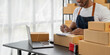 © wichayada - Asian business men use laptop computer checking customer order online shipping boxes at home. Starting Small business entrepreneur SME freelance