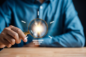 Fototapete - Businessman holding magnifier focus to light bulb icon. mind, creative, idea, innovation, motivation planning development leadership and customer. planing project with new creative concept...