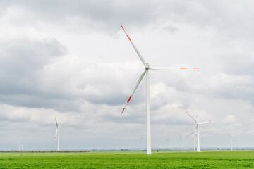 Wind farm in a green field, Wind turbines produce Green Energy.