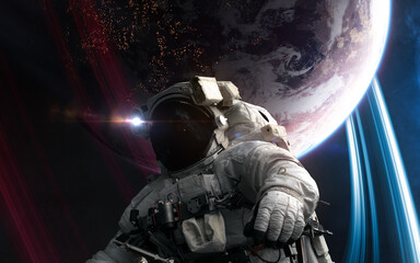 Wall Mural - astronaut in outer space in front of distant inhabited planet. science fiction. elements of this ima
