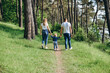 © Oleg - Family photo session on the street on a warm sunny day in a coniferous forest in spring