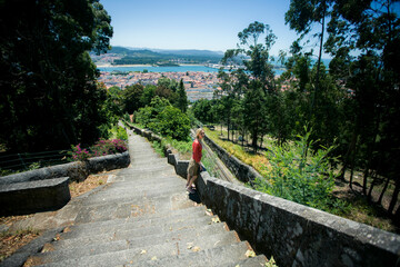 Sticker - A woman on a stone staircase in a medieval park in Viana do Castelo, Portugal.