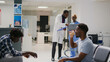 © DC Studio - Team of specialists meeting in facility waiting area to discuss about healthcare medicine or treatment. Nurse and medic talking about checkup report notes at health care reception in lobby.