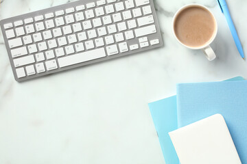 Fototapete - Office desk table with keyboard, coffee cup, blue paper notebooks. Flat lay, top view.