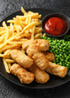 Irish battered sausages with potato fries, green peas and ketchup