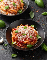 Wall Mural - Italian marinara sauce spaghetti pasta served with fresh basil, olives and pecorino cheese