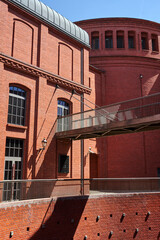 Poster - A metal bridge and a brick walls of a historic brewery from Poznan