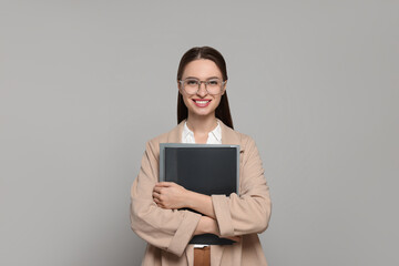 Wall Mural - Portrait of beautiful young teacher on grey background