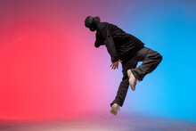 Young Guy Falls Upside Down In The Air, Man Levitates And Flies Down In Neon Lighting, Acrobat Dancer Flies In Jump