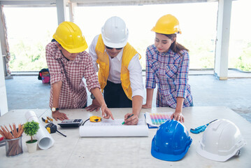 Civil Construction engineer teams shaking hands together wear work helmets worker on construction site. Foreman industry project working engineer teamwork. Two asian engineer team shake hands together