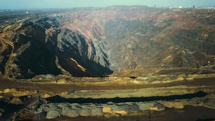 Wall Mural - Panorama aerial view shot open pit mine coal mining, dumpers, quarrying extractive industry stripping work. Big Yellow Mining Trucks. View from drone at opencast mining with lots of machinery trucks