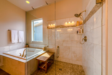 Wall Mural - Modern bathroom with natural lighting from the window at the bathtub beside the shower stall. There is a shower stall with wooden bench shelves on the mosaic floor tiles and frameless glass walls.