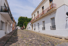Cobblestone Street In The City Of Colonia Del Sacramento In Uruguay With A Rental Car In The Background. February 2023.