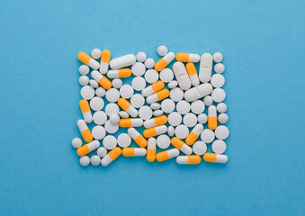 Wall Mural - Different medicinal pills are arranged in a square, from above. Medical dietary supplements concept.