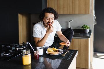 Wall Mural - Hispanic man eating a healthy breakfast at home apartment in Mexico Latin America