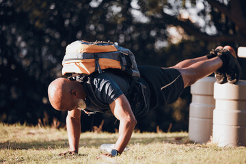 Pushup, strong and black man at a fitness bootcamp for exercise, workout and sports. Active, bodybuilder and athlete doing a cardio challenge, physical activity and strength routine on a field