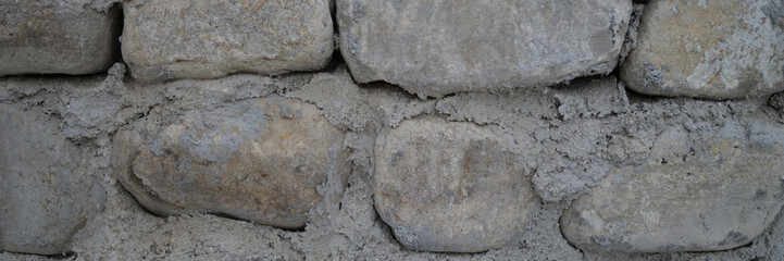 Old castle stone wall texture background. Finishing the facade with stone