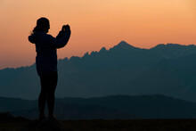Woman Taking Picture With Smartphone In Mountains At Sunset, Aspen, Colorado, USA