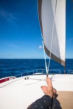 Feet Of Woman Sunbathing On Sailboat