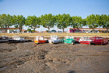 Row Of Multicolored Boats Docked During Low Tide At La Teste-de-Buch, Gironde, France