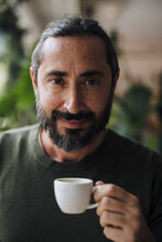 Smiling Bearded Man Holding Coffee Cup