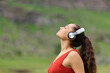© Antonioguillem - Woman meditating listening audio guide in nature