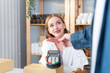 © Wosunan - Young woman small business owner with a credit card payment system