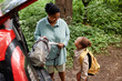 © Seventyfour - High angle portrait of happy black mother and daughter standing by car while travelling together in nature