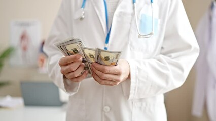 Wall Mural - Young arab man doctor counting dollars at clinic