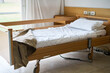 © Robert Kneschke - Blanket and pillow on empty bed in nursing home