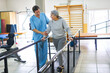 © Robert Kneschke - Physiotherapist assisting elderly woman in movement therapy