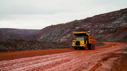 Wall Mural - dump truck transporting iron ore in red iron ore quarry. The red quarry looks like the planet Mars