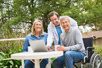 Wall Mural - Doctor discussing with senior couple over laptop in garden