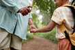 © Seventyfour - Close up of mother using baby safe bug repellent for daughter while hiking together in nature