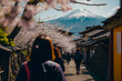 Walking in the park with blooming pink sakura along the street, the villagers of japan in the distance against the backdrop of Mount Fuji volcano. Generative AI