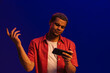 © Drobot Dean - African man frowning and gesturing while playing online game on mobile phone isolated