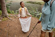 © Seventyfour - High angle portrait of smiling black girl holding trash bag outdoors and helping clean nature with mom