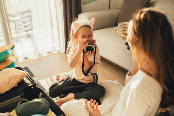 mother and daughter packing before the trip.